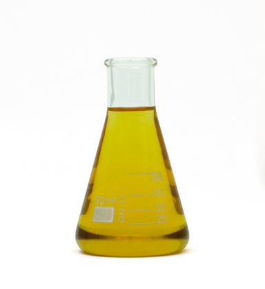 organic clove bud essential oil in beaker